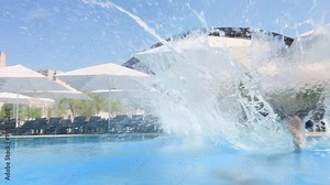 Three friends holding hands and jump in pool