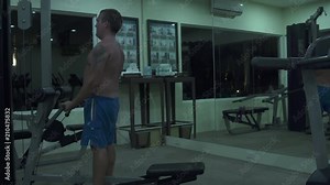 Man performs exercises on the machine at the gym Stock Video
