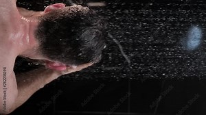 Man washing his hair with shampoo in the shower upper body rear view
