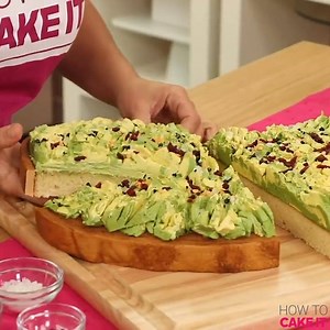 2.7M views · 988 reactions | Anyone craving some avocado toast made of sweet vanilla cake?  We definitely are! This cake version of everyone's brunch favorite is carved into a slice and topped with smashed avocado green and a muted yellow buttercream, then topped with crushed up black dragees as pepper, clear rock candy for salt, and a blend of dried cranberries and yellow gumpaste circles for chili flakes! 陋 Talk about a sweet start to your day! | How To Cake It | Facebook