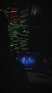 Hooded hacker working on computer. Dark room with devices playing several videos: internet security, program code security interface and fingerprint access. All animations included in my portfolio.