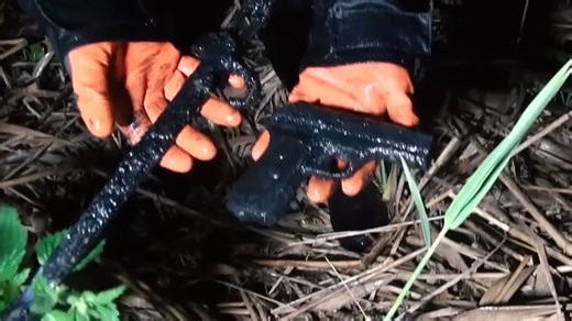 Rifles and wartime relics lifted from a World War II battlefield pond