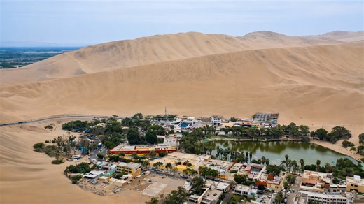 The desert settlement encircled by towering dunes
