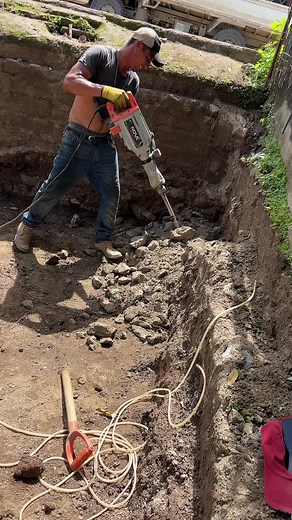 Construction Scene: Man Using Jackhammer for Trenching