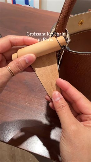 Found the croissant 🥐 keychain in Paris! Sadly, it’s sold out in the US. Tried it on here with a really cute bag. Shop the look: https://shopmy.us/collections/2708400 | Pastry with Jenn