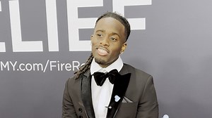 Streamer Kai Cenat is all smiles on the Grammys red carpet