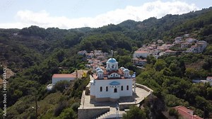 Aerial footage of typical Greek orthodox church on a mountain top in the Aegean island of Samos
