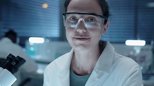 clip-1100849575-chest-portrait-young-female-scientist-protective-glasses