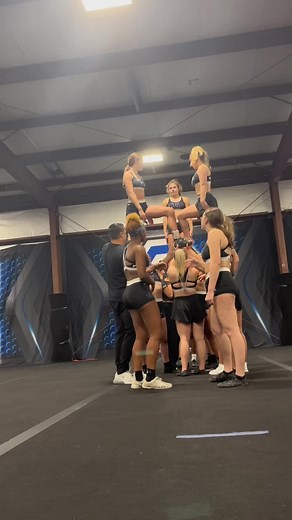 Cheerleaders Perform Stunning Stunt Routine in Gymnasium