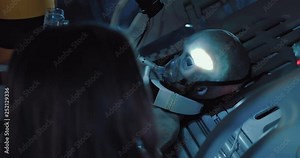 Girl scientist monitors the state of an alien in an operation. Space laboratory, operational unit.