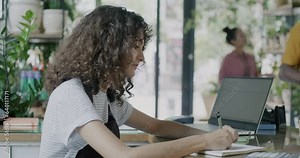 Flower shop owner working with calculator and writing while delivery man carrying plants and client choosing. Business and entrepreneurs concept.