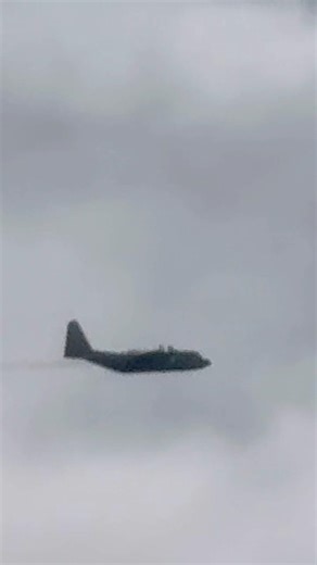 US AIR FORCE C130 gaining altitude in the clouds