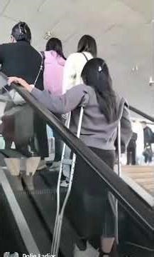 Shortleg polio girl using the escalators.