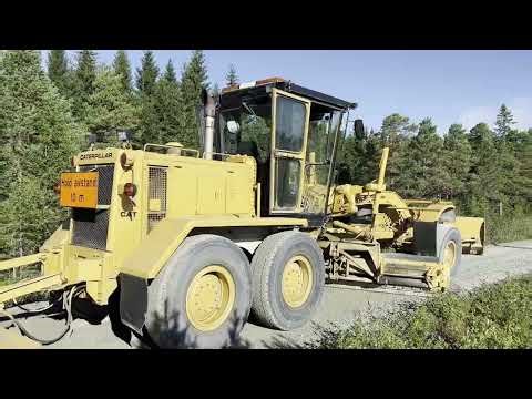 Old vintage, but refurbished motor grader working - Tractor gravel road grading