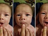 Baby 'sings' Christmas carol - with a little help from daddy