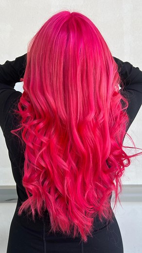 Red-pink hair exudes confidence, creativity, and passion — a perfect choice for someone who loves standing out and expressing individuality | Cleos Hair Design