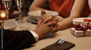 Romantic couple dining together and holding hands