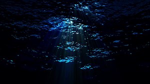 Download Dark underwater ocean waves ripple and flow with light rays - Loop for free