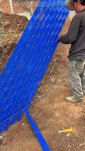 Weaving Blue Strips: Transforming Wire Mesh into a Vibrant Barrier