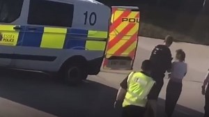 Woman led from plane after attacking flight crew