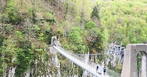 Young couple hiking in the Basque Country near the Holzarte footbridge