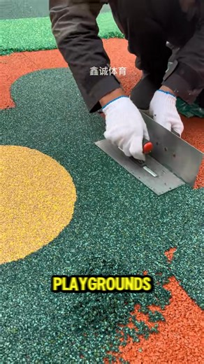 Constructing resilient floor surface by spreading and flattening rubber granule material | Elmwood Studio Tv
