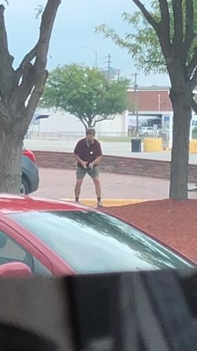 old man bouncing golf ball with hammer in parking lot