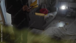A detective woman investigates an indoor crime scene with evidence markers and a body outline