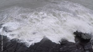 Devil's eye goa in monsoon. It is also known as devil's finger near Sinquerim Fort to Lower Aguada. Water waves crash into rocks and Sea foam creating amazing shapes and patterns
