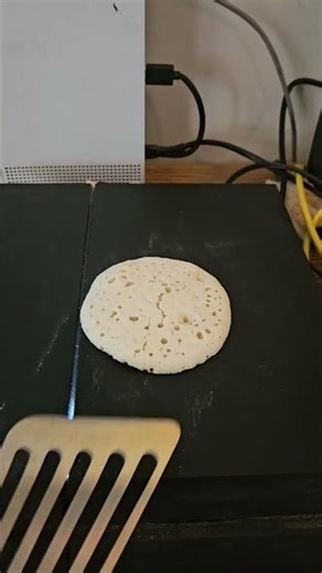 Man humorously cooks pancakes on a PlayStation 4 in Newnan, Georgia, USA