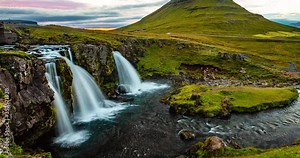Iceland time lapse video of waterfall and famous mountain. Kirkjufellsfoss and Kirkjufell in northern Iceland nature landscape. Amazing timelapse photography in 4K HDR.