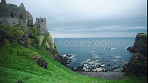 Ruins Of Dunluce Castle In County Antrim, Northern Ireland, UK With A Beautiful Scenery Of The Blue Ocean. - wide shot