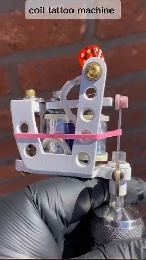 A coil tattoo machine is a tool used to create tattoos by injecting ink into the skin. It works by using electromagnetic coils to generate an up-and-down movement of the tattoo needle. When the machine is turned on, electrical current flows through the coils, creating a magnetic field that attracts and releases the needle quickly, forming lines or patterns on the skin. This machine is commonly used by professional tattoo artists due to its precision in controlling the needle's depth and speed. #