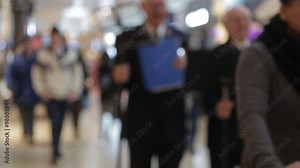 Blur background of shopping mall and crowd of walking people in the shopping mall center with bokeh