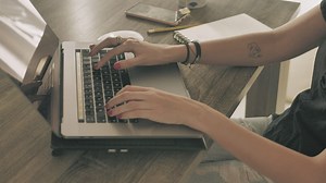 Hands of a girl working on a computer - Free Stock Video