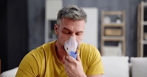 Asthma Patient Breathing Using Oxygen Mask And COPD Nebulizer