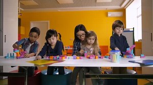Kids playing with construction blocks in classroom