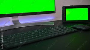 Modern Personal Computer, tablet and phone with Mock-up Green Screen Display Standing on the Desk of the Office.