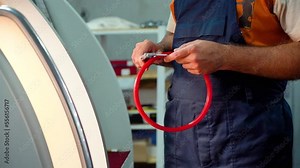 Production of seals on the CNC machine. the worker measures the dimensions of the rubber gasket with a vernier caliper