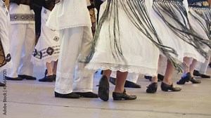 Traditional romanian folklore dancers in traditional costumes dancing on stage