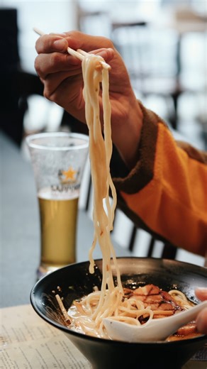 Ramen and beer aren’t just for unwinding; they’re made for each other. 🍜🍻 Light Japanese beers like Sapporo are brewed to complement tonkotsu ramen: crisp enough to cleanse the palate and refreshing enough to reset between slurps. Every sip allows our full-bodied broth to shine, with room for you to savor our sides like gyoza in between. Enjoy the ramen and beer pairing experience at #RamenYushoken. | Ramen Yushoken