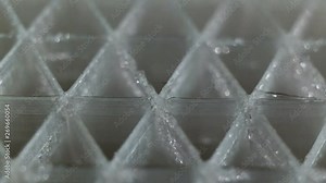 The grid inside the 3D printed model, skeleton, skeleton, ribs extreme closeup. Triangular mesh transparent plastic PETG glitters and shimmers, real time