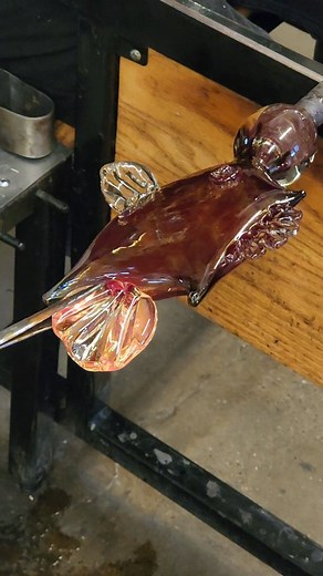 Christian got creative and made this funky fish for a demo a while back 🐠 It's always fun to see what new shapes and designs our artists come up with! #fish #glass #art #glassblowing #summer #fathersday #cool | Akron Glass Works