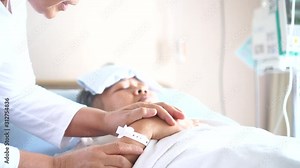 Woman Visits Best friends holding hands for recovering that sick lying sleep in Hospital, looking with cheerful love hopeful emotional, Encouragement comforting Recovering from family healthy moment.