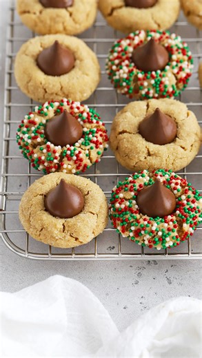 🎄 Classic Gluten-Free Peanut Butter Blossoms made BETTER! We use a few little tricks to give the cookies the BEST texture possible (aka they’re not dry & boring!) and have tons of fun ways to mix them up, from swapping out toppings to adding extras inside! ✨ Want to make a batch? Comment “recipe” below and I’ll send you the link! (Or search “Sweets & Thank You Peanut Butter Blossoms” to find it on your own. https://sweetsandthankyou.com/gluten-free-peanut-butter-blossoms/ #PeanutButterBlossoms 