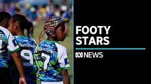 VIDEO: Junior footy stars cross the sea to compete in league tournament