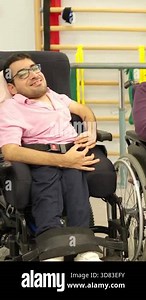 Cheerful group of friends with physical disabilities happily chatting in a rehabilitation center