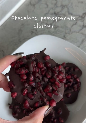 Chocolate Pomegranate Clusters 🍫 These are my new favorite! So simple and yummy Ingredients * Pomegranate or pomegranate arils * Dark Chocolate chips (pascha or lily’s brand, has low sugar or no sugar) * Coconut oil or oil Directions 1. Melt chocolate chips in a pan or pot w some oil 2. Cover a baking sheet, board or pan with parchment paper. Anything flat tbh 3. Add spoonfuls of chocolate, then spoonfuls of pomegranates 4. Drizzle the leftover chocolate on top 5. Optional: sprinkle with salt 6