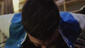 Young brunette boy in sport jacket press up from floor seven times and then falling. Exercise. Sport