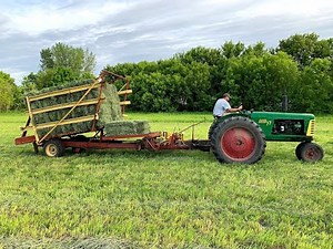 1st crop grass small squares using a John Deere 336 and a New Holland stackliner.